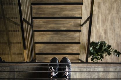 person standing near railing looking down